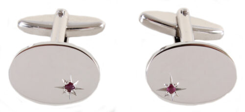 Oval rhodium cufflinks with star set ruby.